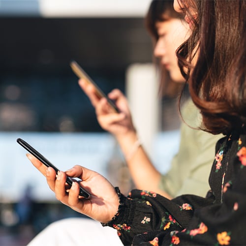 Two people looking at their phones
