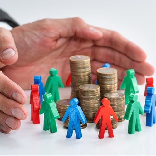A person collecting coins and assembling them in front of figurines