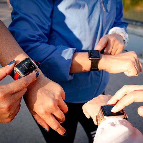 People setting their smart watches