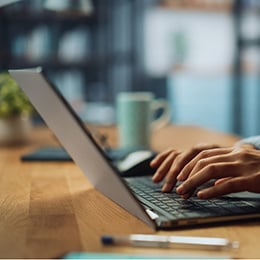 A person typing on a keyboard