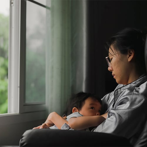 A woman holding her baby