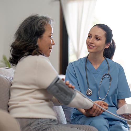 A nurse checking a patient's blood pressure